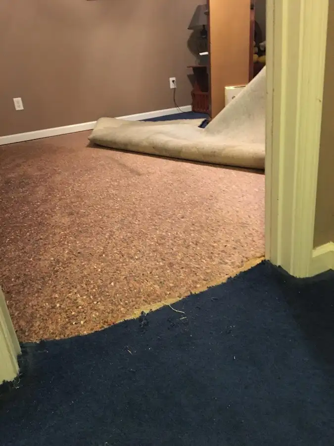 Carpet pad removal revealing water damage during Water Mitigation Services in Tega Cay